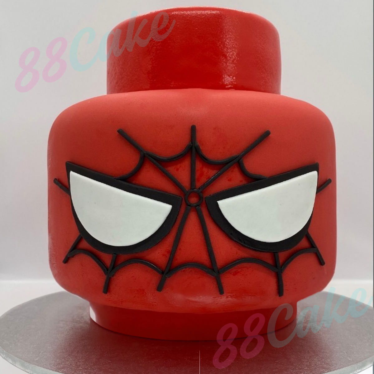 Lego head shaped cake with spider man decorations