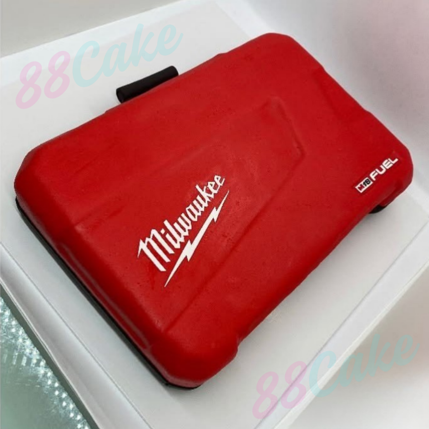 Red Milwaukee tool box shaped cake with '88Cake' branding.