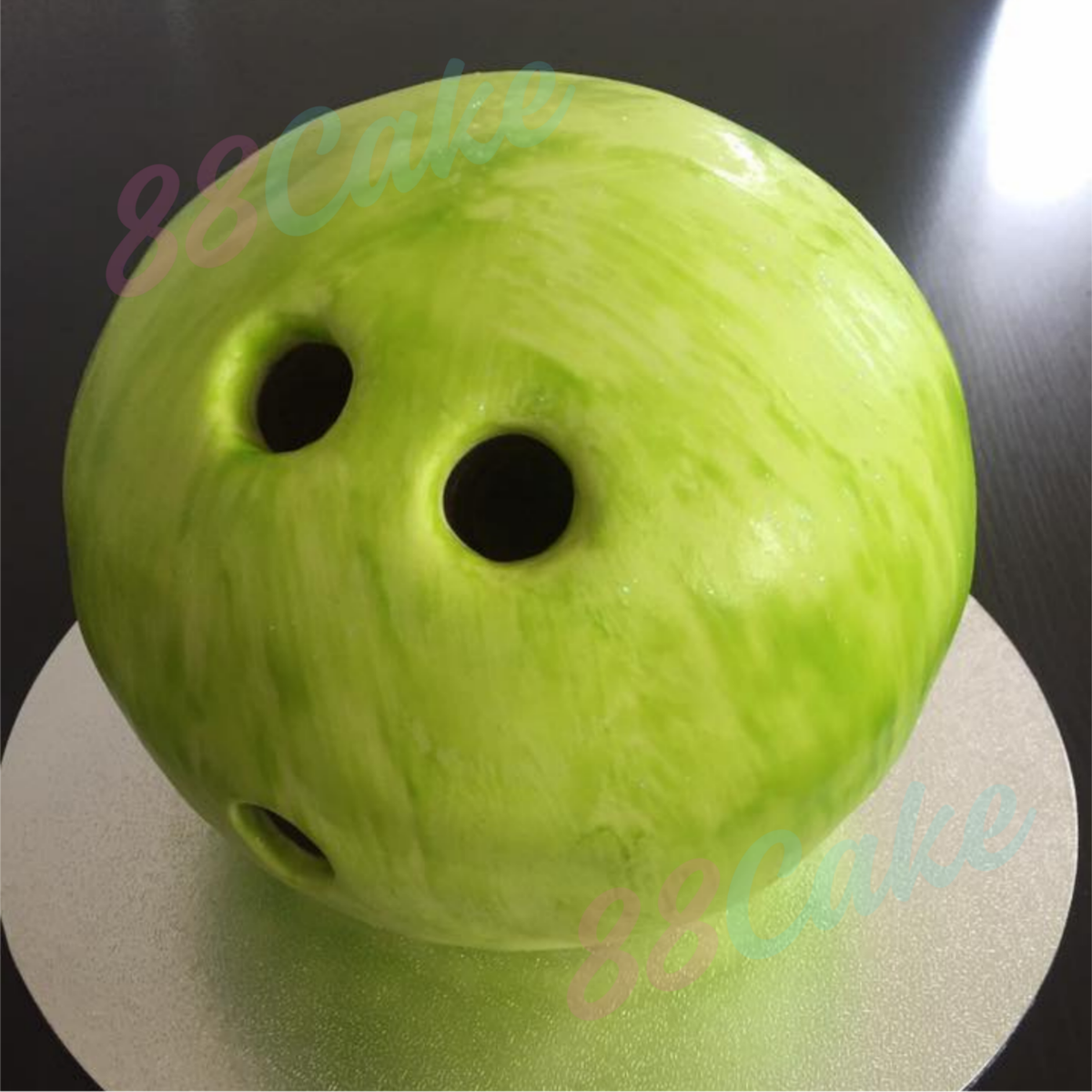 Green bowling ball shaped cake