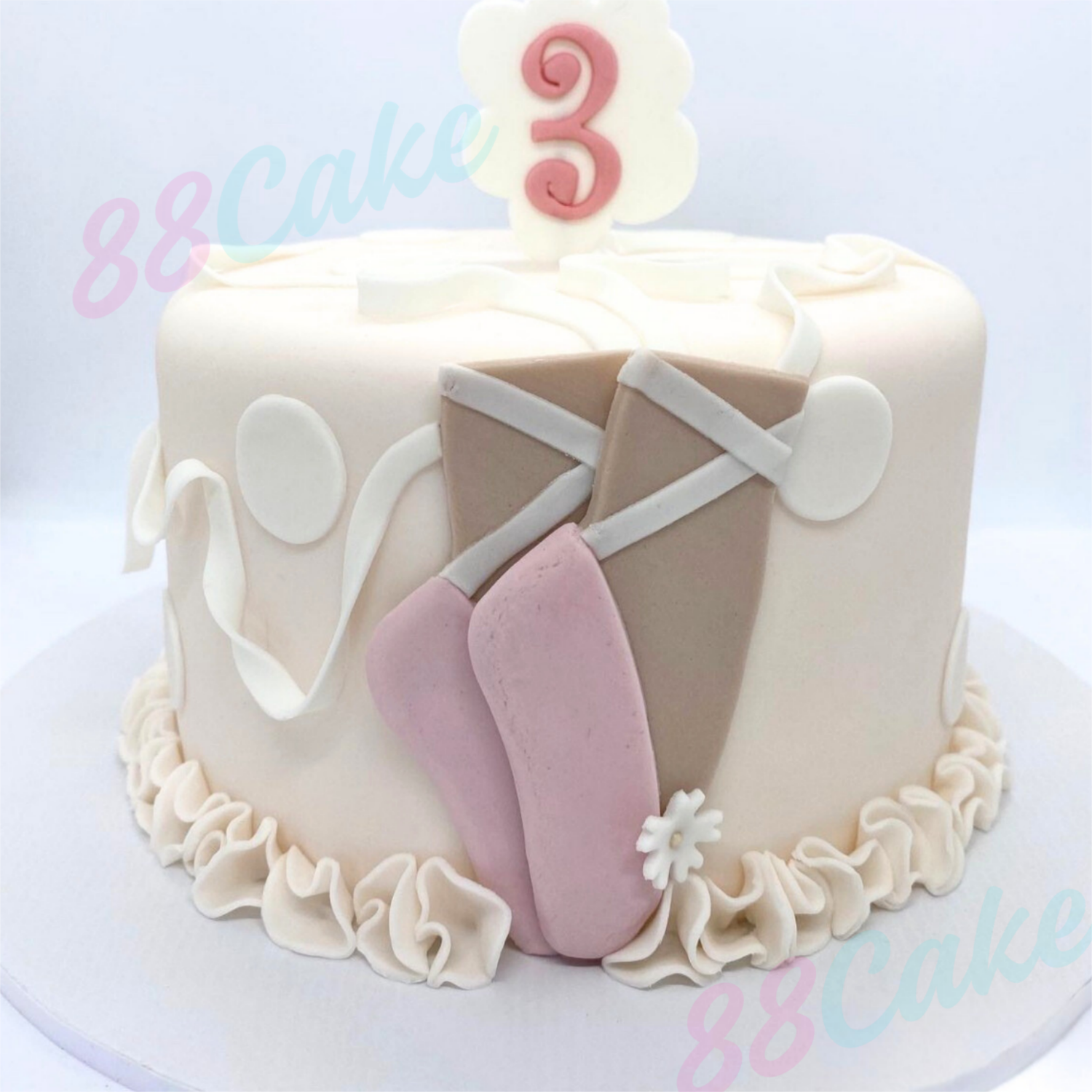 Pink cake with ballet-themed design 