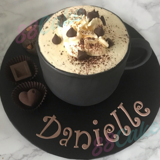 Hot chocolate mug shaped cake with whipped cream and chocolate chips  personalised with name