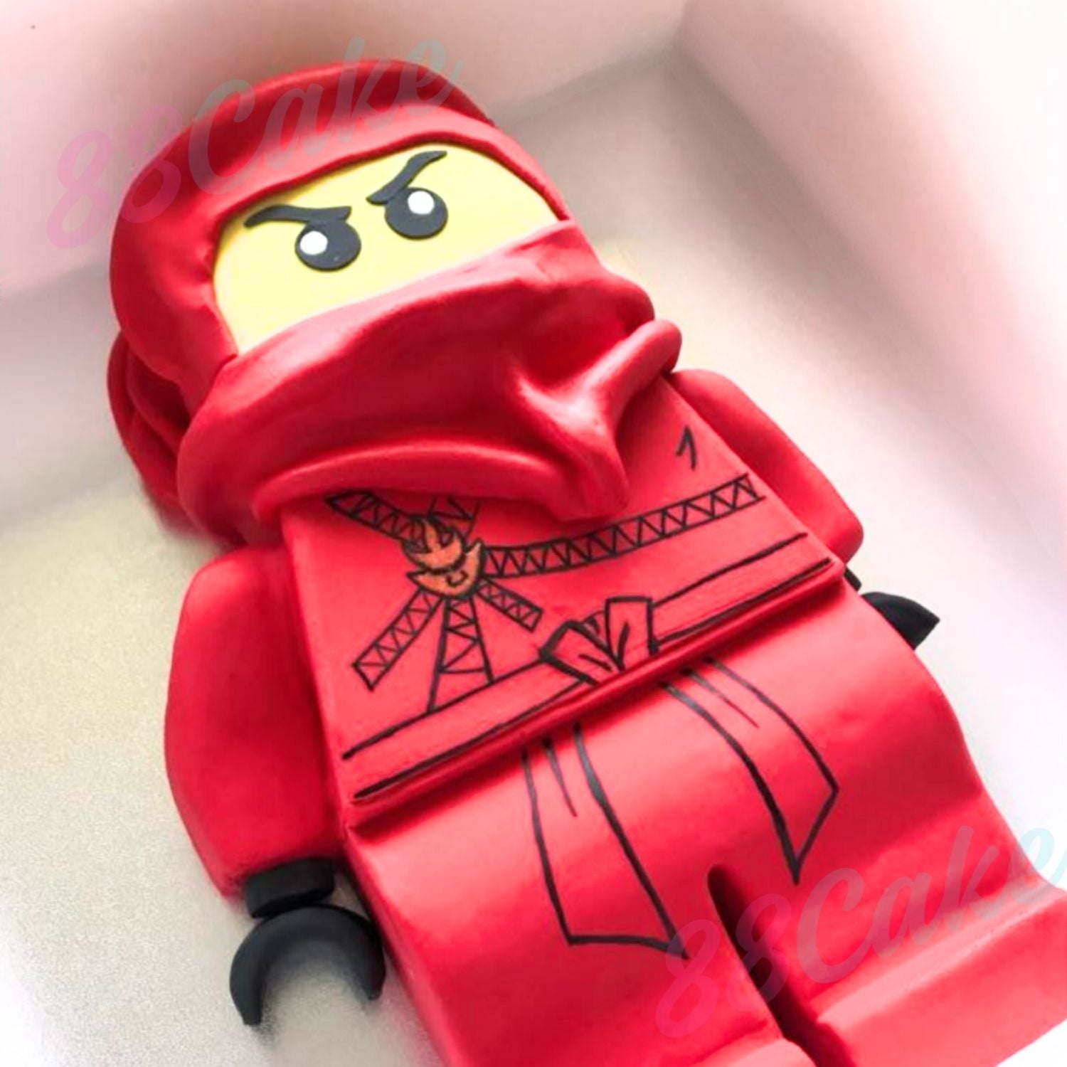 Red Lego figure shaped cake