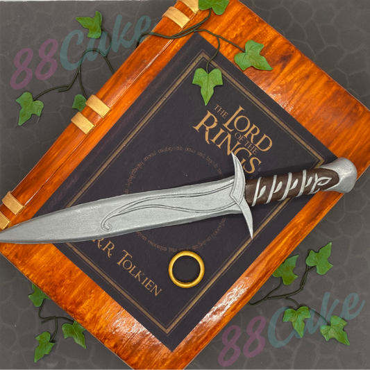 Cake designed to look like 'The Lord of the Rings' book with a sword on top, featuring the '88Cake' branding.