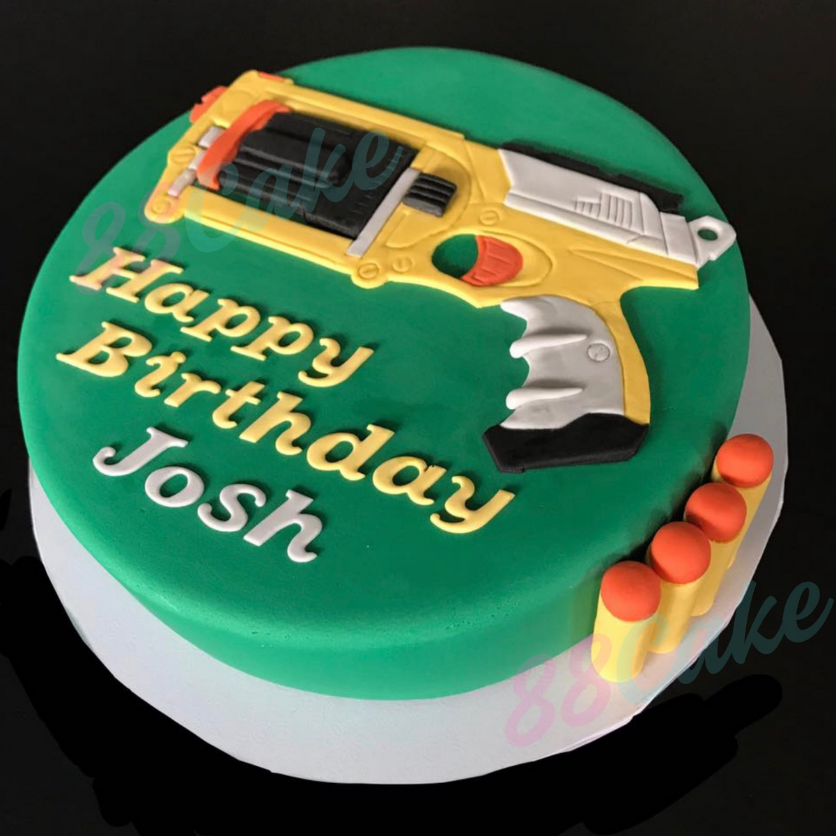 Birthday cake with a hand detailed nerf gun and nerf gun bullets