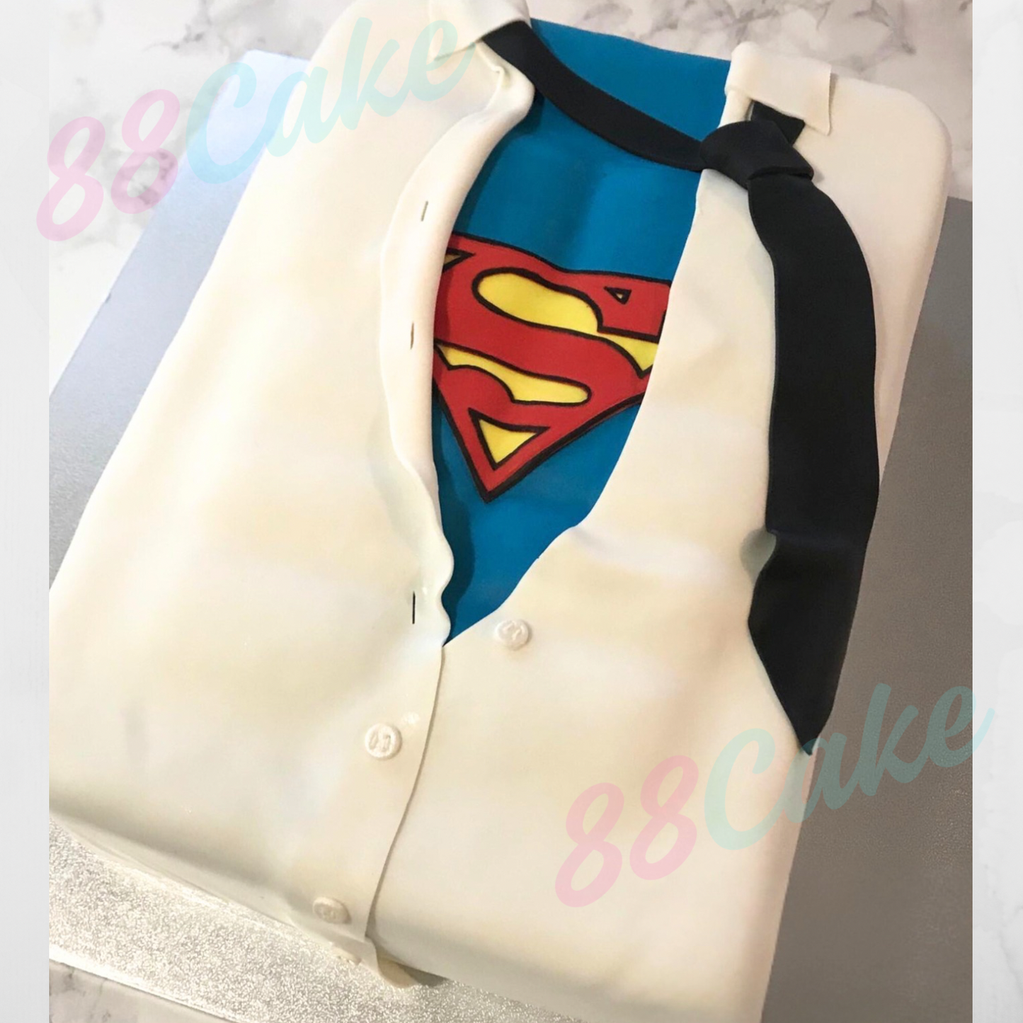 Superman themed cake with a shirt and tie