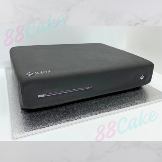 Black Xbox console cake on a white background with '88Cake' branding.